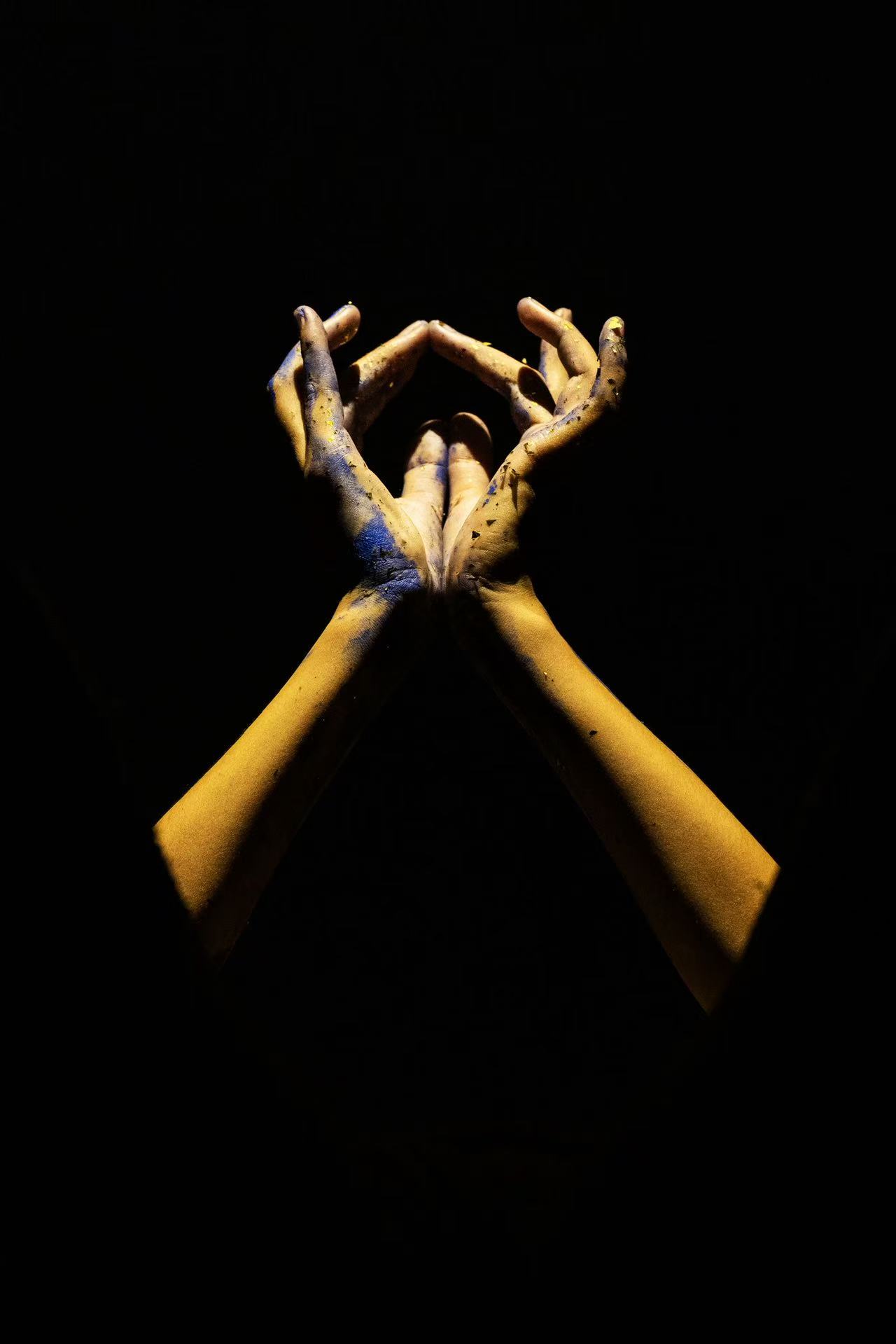 Close view of overlapping hands against black