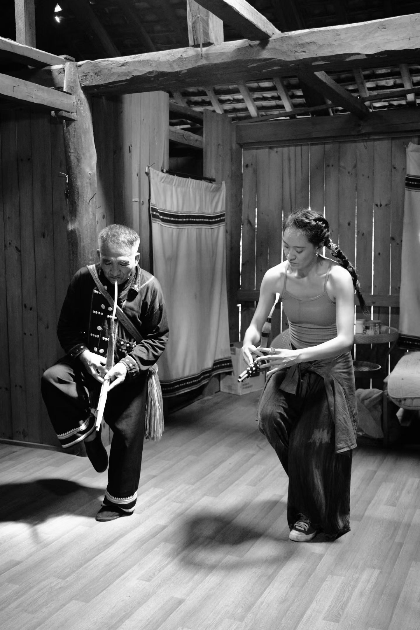 Dong Jilan learning a folk instrument from a heritage practitioner